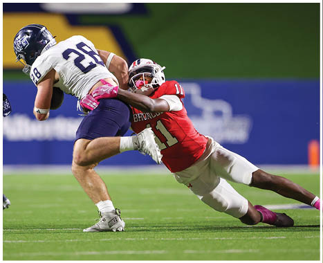 A football player running on the field. Description generated by AI