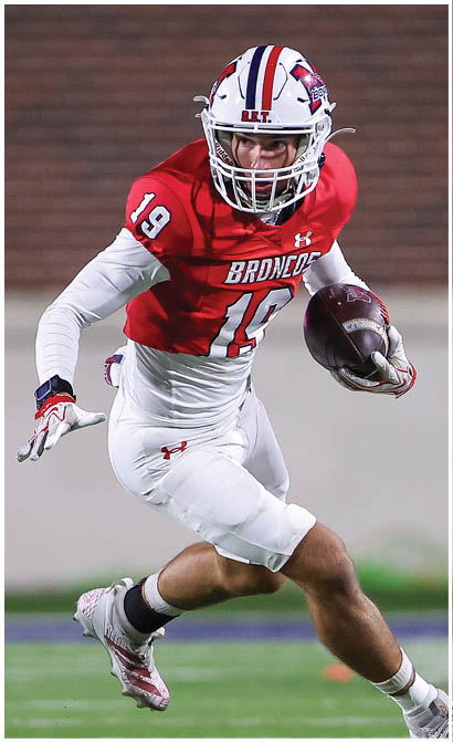 A football player running on the field. Description generated by AI