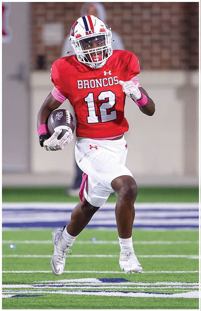 A football player running on the field. Description generated by AI