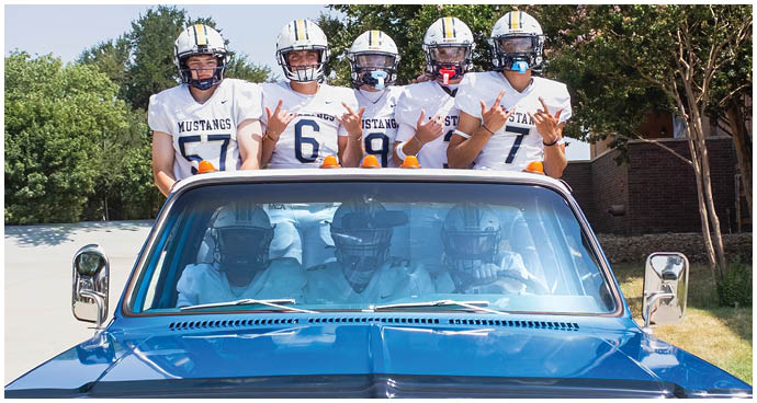 A group of football players wearing black and white uniforms. Description generated by AI