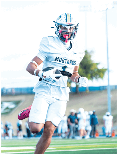 A football player wearing a blue and white uniform. Description generated by AI