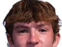 A young man wearing a white jersey with the number 10 on it. Description generated by AI