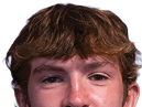 A young man wearing a white jersey with the number 10 on it. Description generated by AI