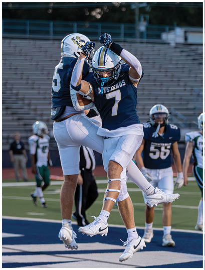 A football player wearing a blue and white uniform. Description generated by AI
