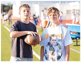 A group of football players on a field. Description generated by AI