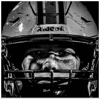 A football player is sliding on the ground. Description generated by AI