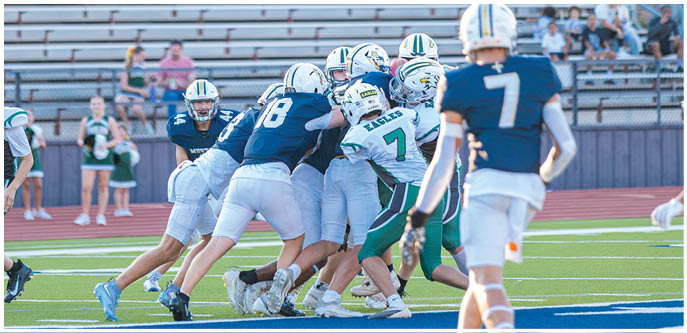 A group of football players on a field. Description generated by AI