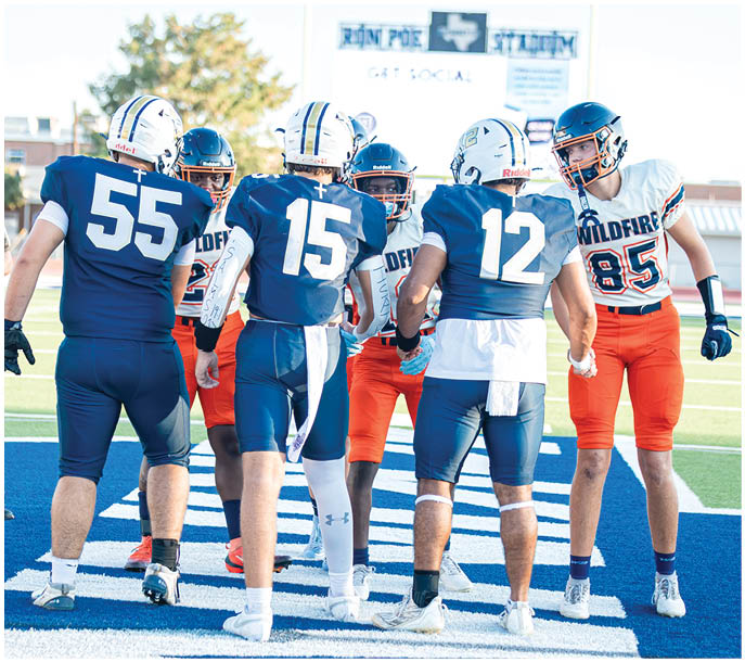 A group of football players on a field. Description generated by AI
