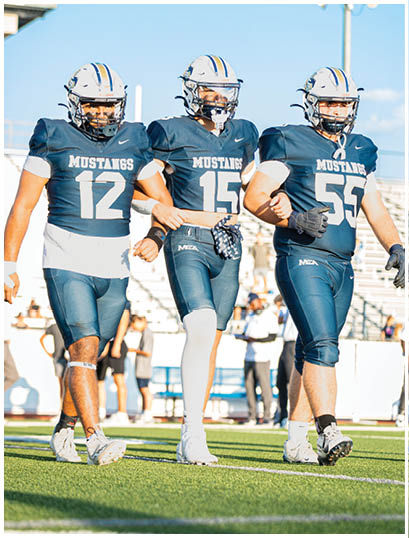 A football player wearing a blue and white uniform. Description generated by AI