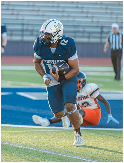 A football player wearing a blue and white uniform. Description generated by AI