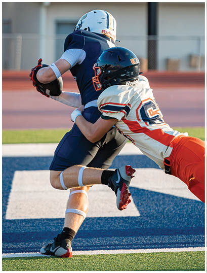 A football player wearing a blue and white uniform. Description generated by AI