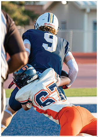 A group of football players wearing black and white uniforms. Description generated by AI