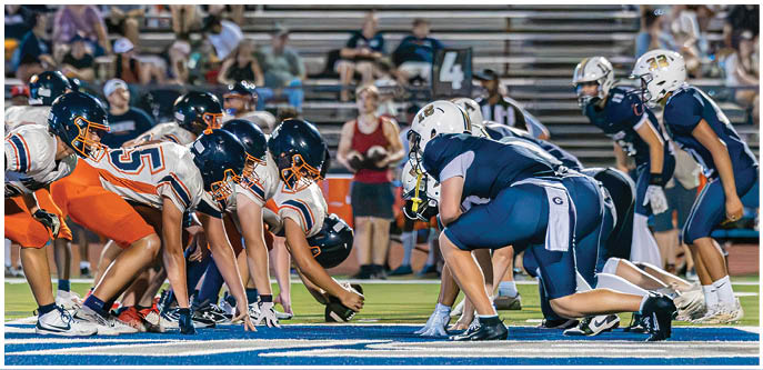 A group of football players on a field. Description generated by AI