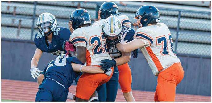 A group of football players on a field. Description generated by AI