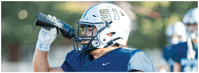 A football player wearing a blue and white uniform. Description generated by AI