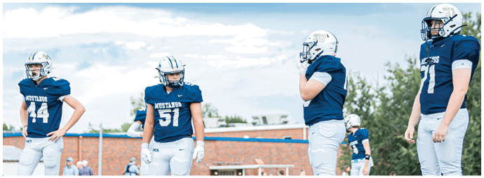 A football player wearing a blue and white uniform. Description generated by AI