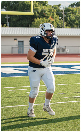 A football player catching a ball. Description generated by AI