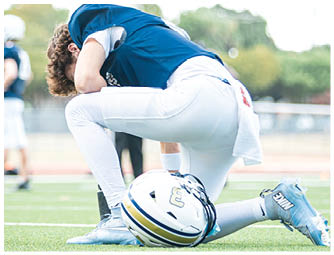 A group of football players on a field. Description generated by AI
