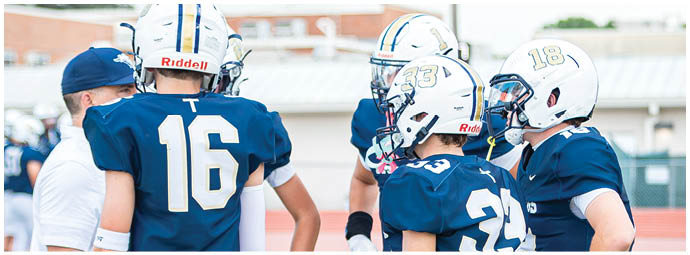 A football player wearing a blue and white uniform. Description generated by AI