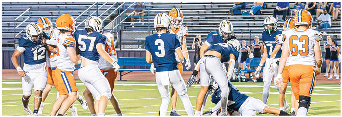 A group of football players on a field. Description generated by AI