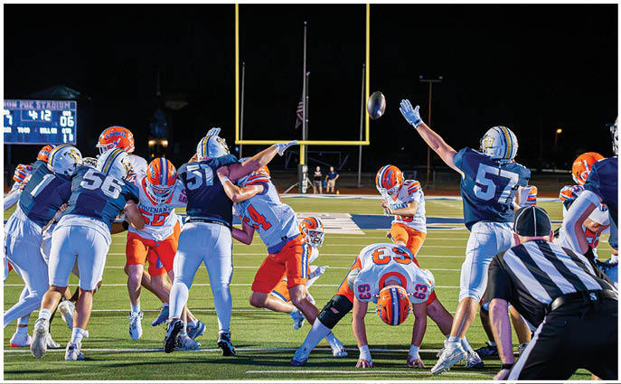 A group of football players on a field. Description generated by AI