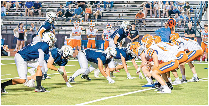 A group of football players on a field. Description generated by AI