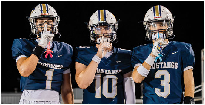 A group of football players on a field. Description generated by AI