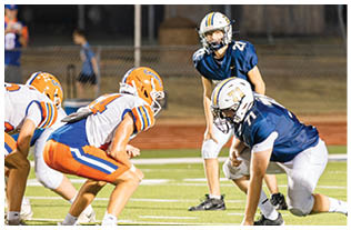 A group of football players on a field. Description generated by AI