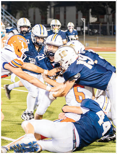 A football player wearing a blue and white uniform. Description generated by AI