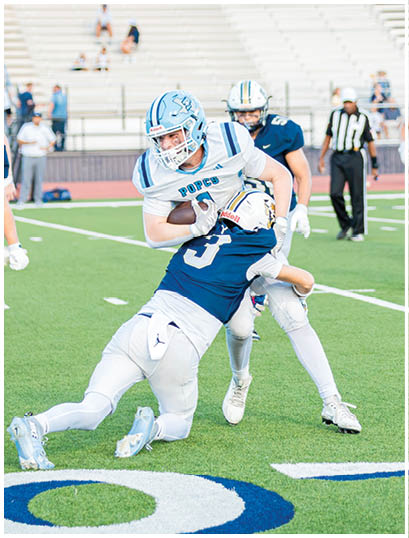 A football player wearing a blue and white uniform. Description generated by AI