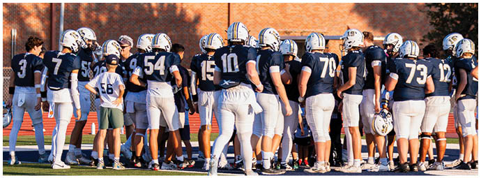 A football player wearing a blue and white uniform. Description generated by AI