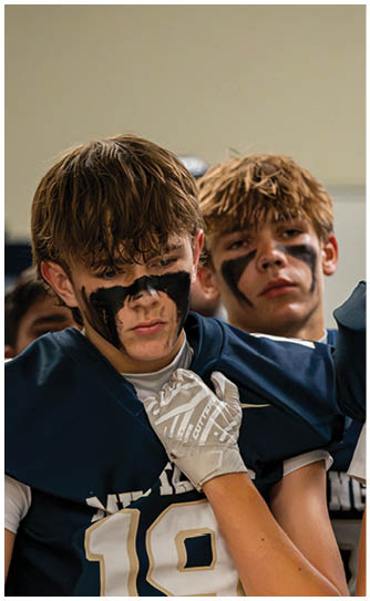 A football player catching a ball. Description generated by AI