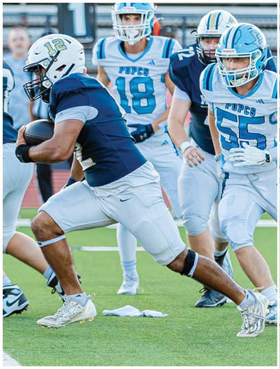 A football player wearing a blue and white uniform. Description generated by AI