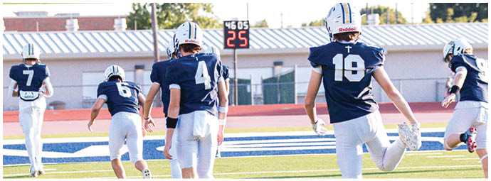 A football player wearing a blue and white uniform. Description generated by AI