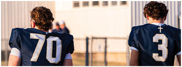 A football player wearing a blue and white uniform. Description generated by AI