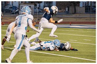A group of football players on a field. Description generated by AI