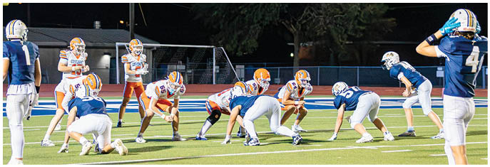 A group of football players on a field. Description generated by AI