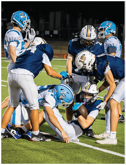 A football player wearing a blue and white uniform. Description generated by AI
