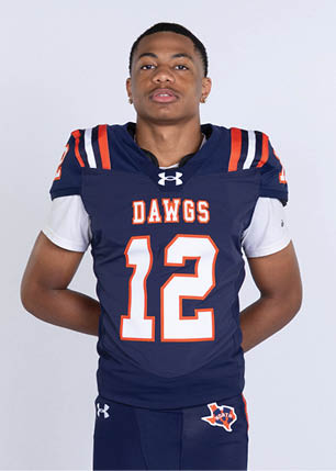 A young man wearing a white and black jersey with the number 14 on it. Description generated by AI