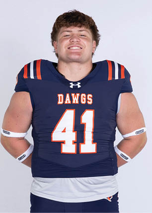 A young man wearing a white and black jersey with the number 14 on it. Description generated by AI