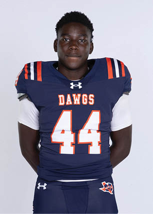A young man wearing a white and black jersey with the number 14 on it. Description generated by AI