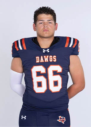 A young man wearing a white and black jersey with the number 14 on it. Description generated by AI