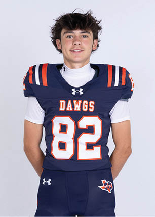 A young man wearing a white and black jersey with the number 14 on it. Description generated by AI