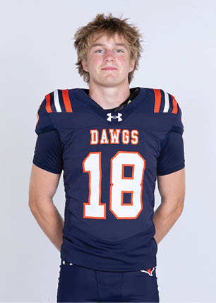 A young man wearing a white and black jersey with the number 14 on it. Description generated by AI