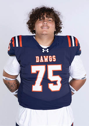 A young man wearing a white and black jersey with the number 14 on it. Description generated by AI