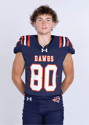 A young man wearing a white and black jersey with the number 14 on it. Description generated by AI