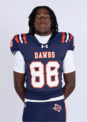A young man wearing a white and black jersey with the number 14 on it. Description generated by AI