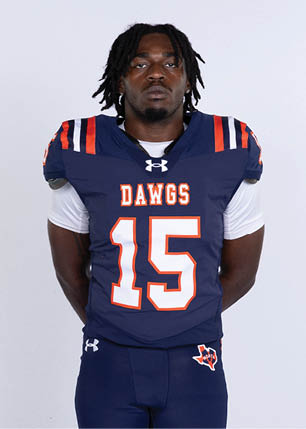 A young man wearing a white and black jersey with the number 14 on it. Description generated by AI