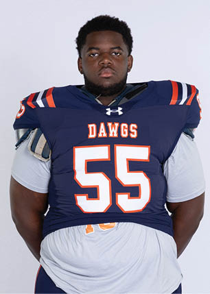 A young man wearing a white and black jersey with the number 14 on it. Description generated by AI
