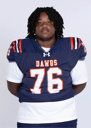 A young man wearing a white and black jersey with the number 14 on it. Description generated by AI